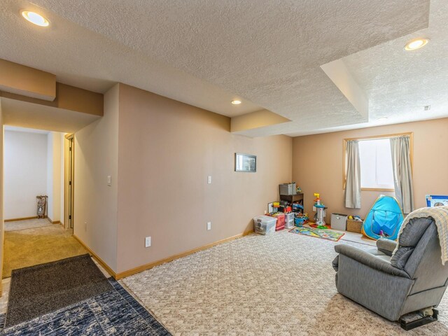 living room with a textured ceiling and carpet flooring