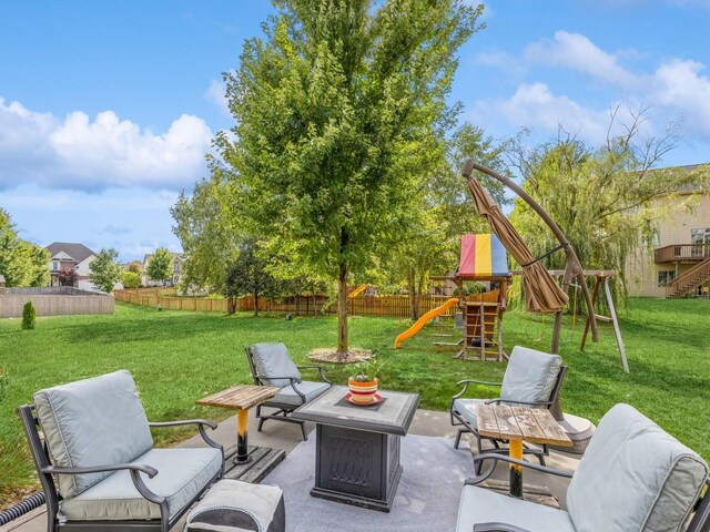 view of patio / terrace with a playground and an outdoor fire pit