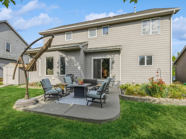 rear view of property featuring a fire pit, a lawn, a storage unit, and a patio area