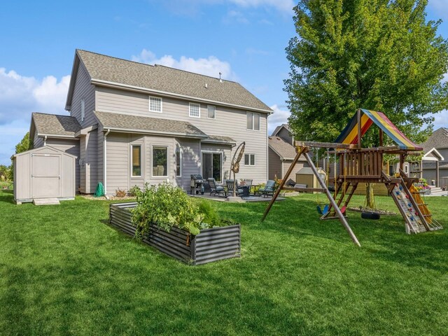 back of property with a storage unit, a patio, a playground, and a lawn