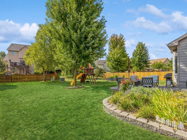 view of yard with a playground and a patio area