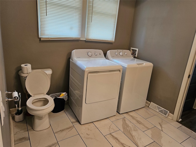 laundry room with washing machine and clothes dryer