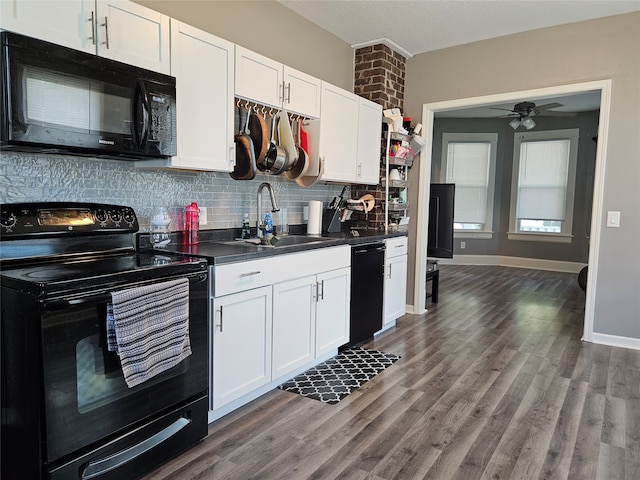 kitchen with dark hardwood / wood-style floors, black appliances, white cabinetry, and sink