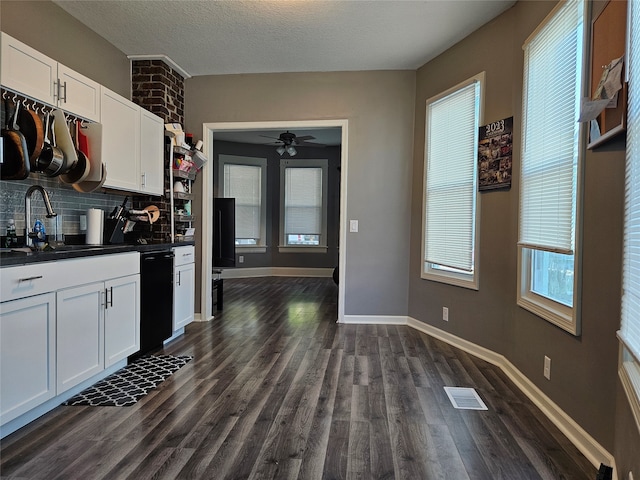 kitchen featuring black dishwasher, dark hardwood / wood-style floors, sink, white cabinets, and decorative backsplash