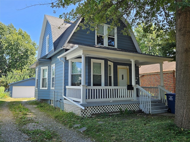 view of front of property with an outbuilding, a porch, and a garage