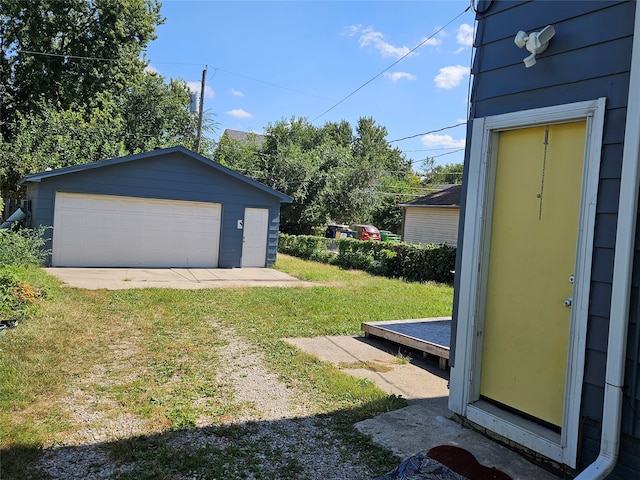 view of yard with an outbuilding, a deck, and a garage