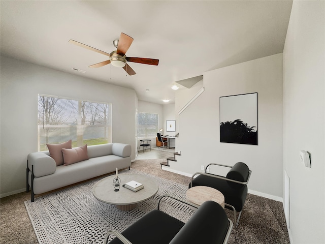 living room with ceiling fan and carpet flooring