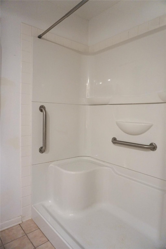 bathroom with tile patterned floors and a shower