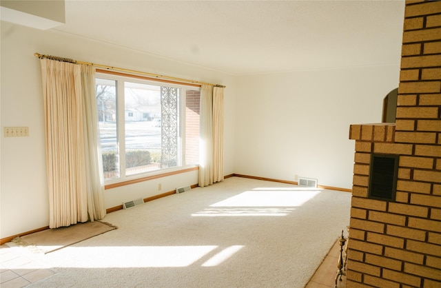 unfurnished living room with visible vents and a fireplace