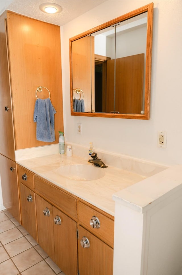 bathroom featuring vanity, tile patterned floors, and a textured ceiling