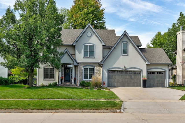 view of front of home with a front lawn and a garage