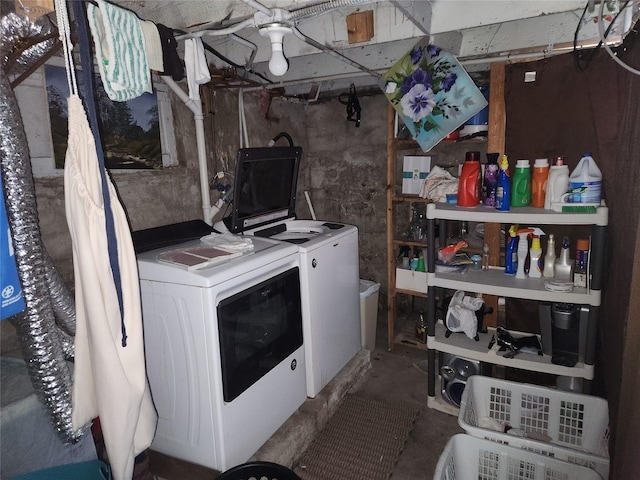 clothes washing area featuring washing machine and clothes dryer and laundry area