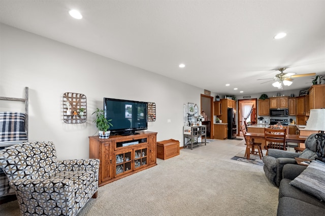 living room with ceiling fan and light colored carpet