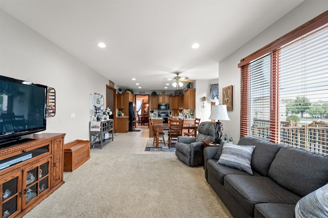 carpeted living room featuring ceiling fan