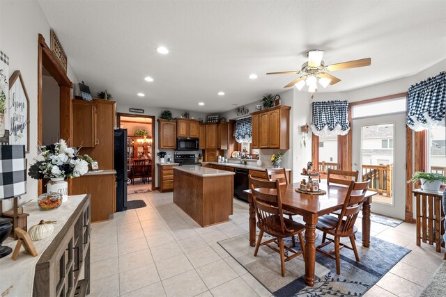 tiled dining space featuring ceiling fan