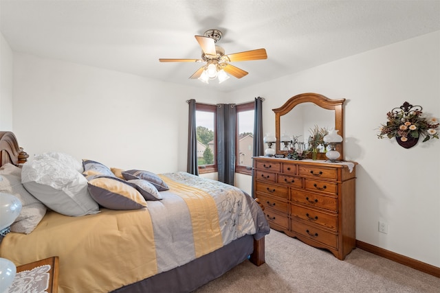 bedroom featuring ceiling fan and light colored carpet