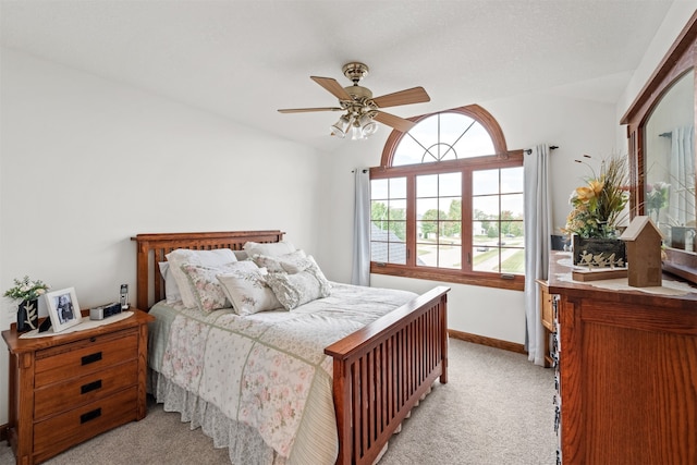 carpeted bedroom with ceiling fan and lofted ceiling