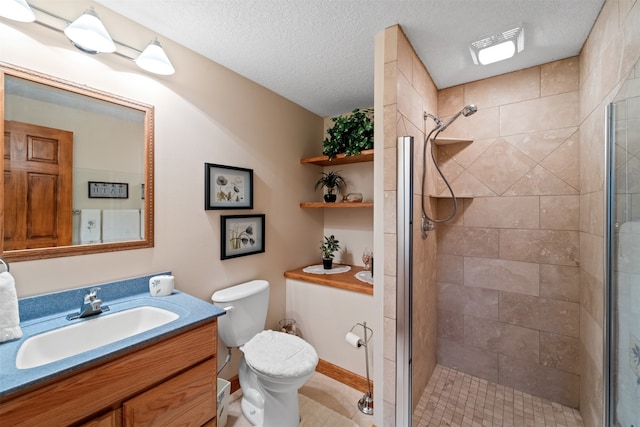 bathroom featuring vanity, a textured ceiling, tile patterned flooring, a shower with door, and toilet