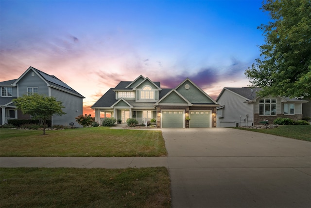 craftsman house with a garage and a yard