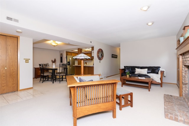 living room featuring a fireplace and light colored carpet