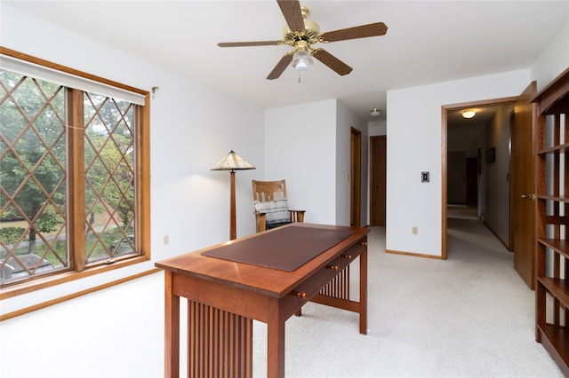 office area with ceiling fan and light carpet