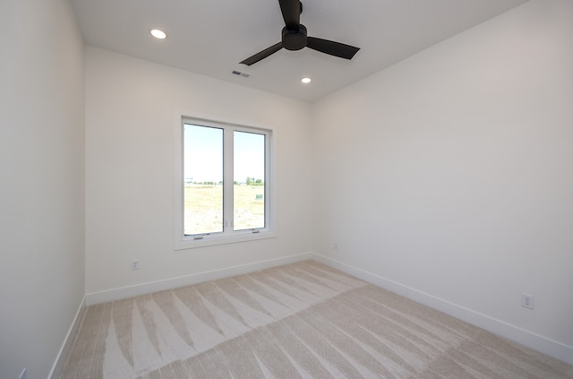 empty room featuring light carpet and ceiling fan