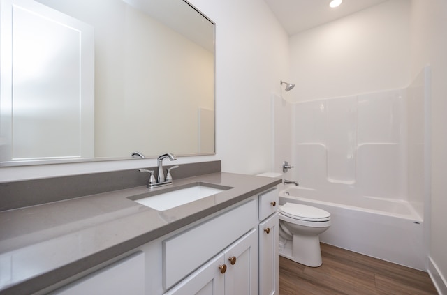 full bathroom with vanity, hardwood / wood-style floors, shower / bathtub combination, and toilet