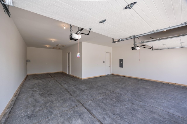 garage with baseboards, a garage door opener, and electric panel
