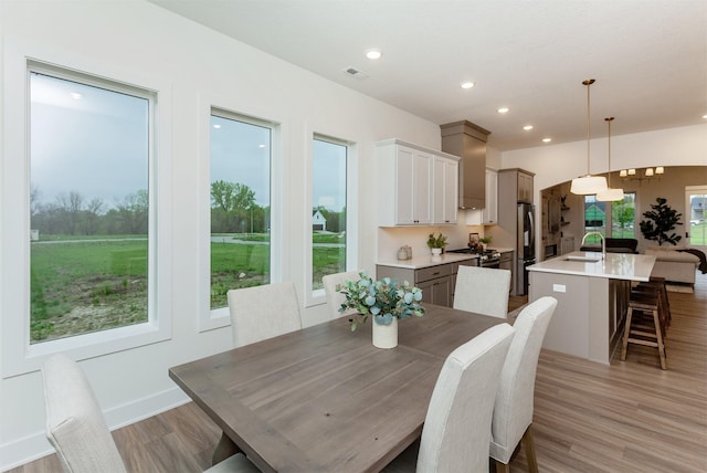 dining room featuring recessed lighting, visible vents, and light wood-type flooring