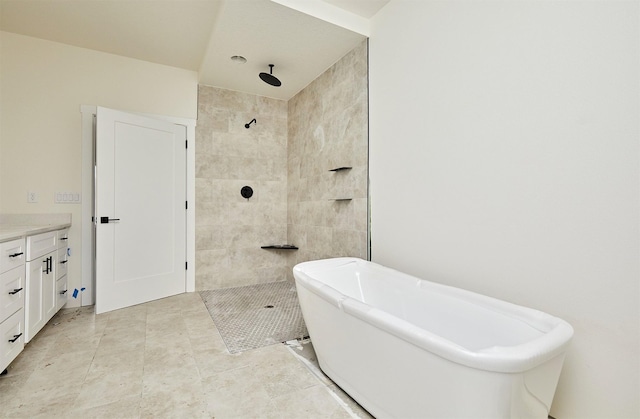 bathroom with a soaking tub, a walk in shower, and vanity