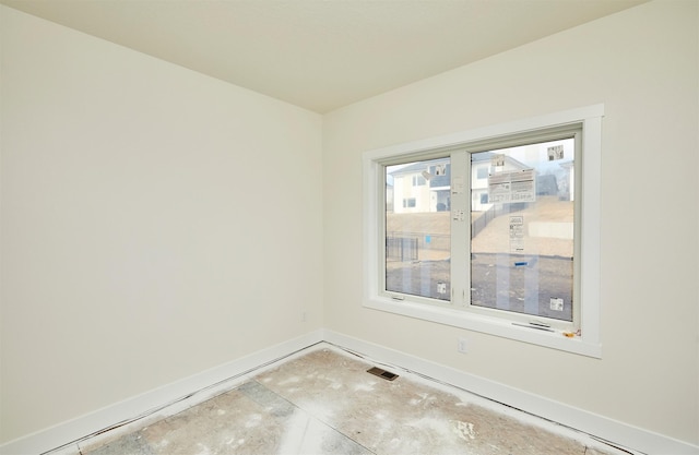 unfurnished room featuring visible vents and baseboards