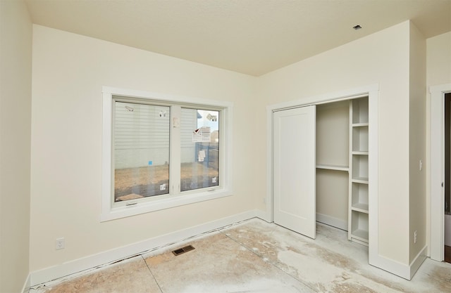 unfurnished bedroom with baseboards and visible vents