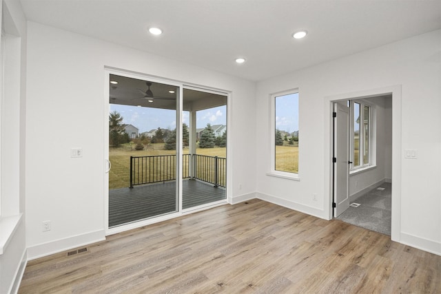 spare room featuring ceiling fan and light hardwood / wood-style flooring