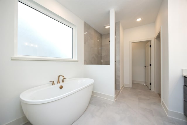 bathroom featuring vanity and independent shower and bath