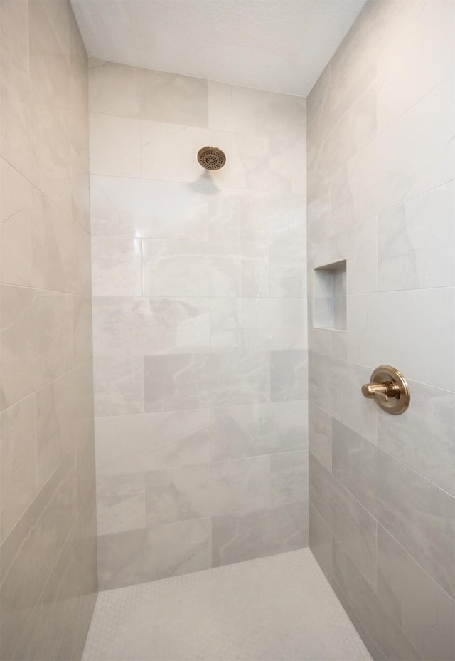 bathroom with tiled shower