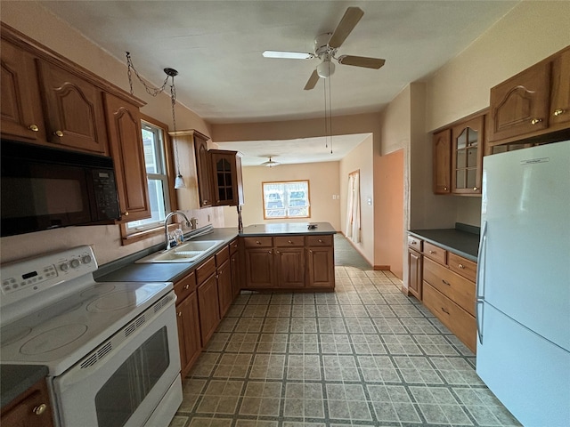 kitchen with white appliances, kitchen peninsula, pendant lighting, ceiling fan, and sink