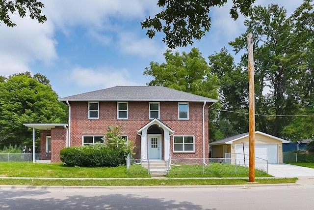 view of front of property with a garage, an outdoor structure, and a front lawn