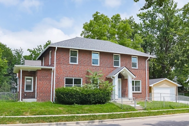 view of front of home featuring an outbuilding, a garage, and a front yard