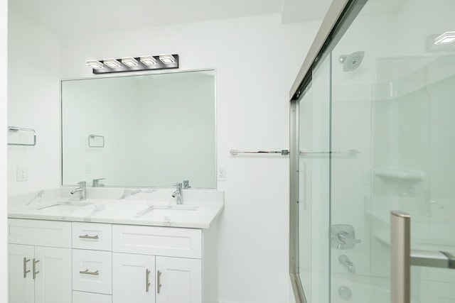 bathroom with vanity and shower / bath combination with glass door