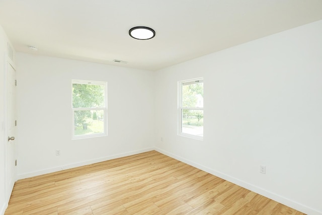 unfurnished room with light wood-type flooring