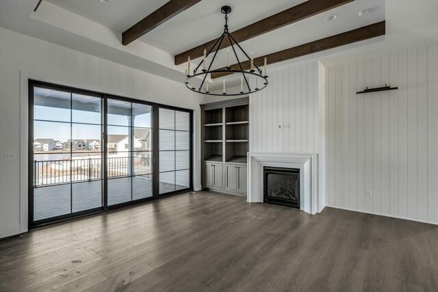 unfurnished living room featuring dark hardwood / wood-style flooring, wood walls, and beamed ceiling