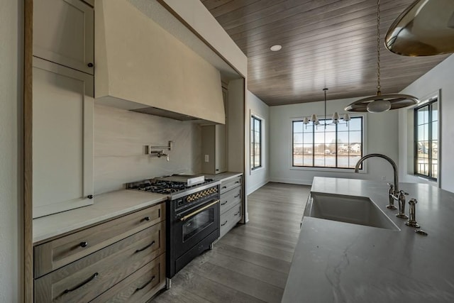 kitchen with wood ceiling, dark wood-type flooring, double oven range, sink, and light stone counters