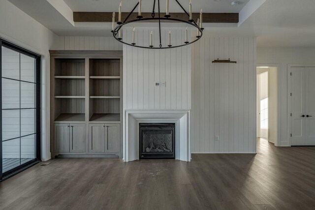 unfurnished living room featuring dark wood-type flooring and wooden walls