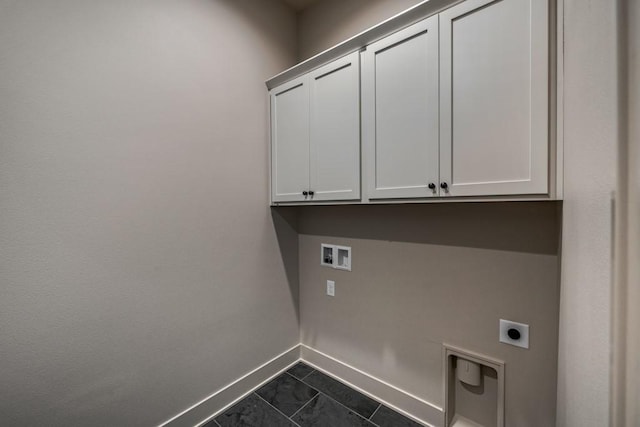 laundry area with hookup for a washing machine, cabinets, dark tile patterned flooring, and hookup for an electric dryer