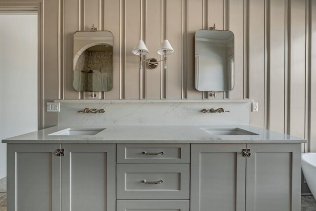 bathroom with a tub and vanity