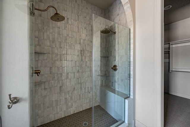 bathroom with a tile shower