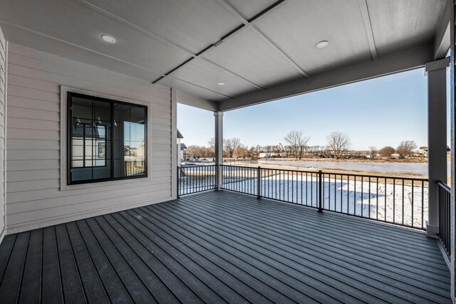 wooden terrace featuring a water view