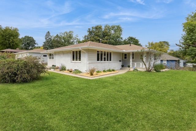 back of property featuring a lawn, covered porch, and brick siding