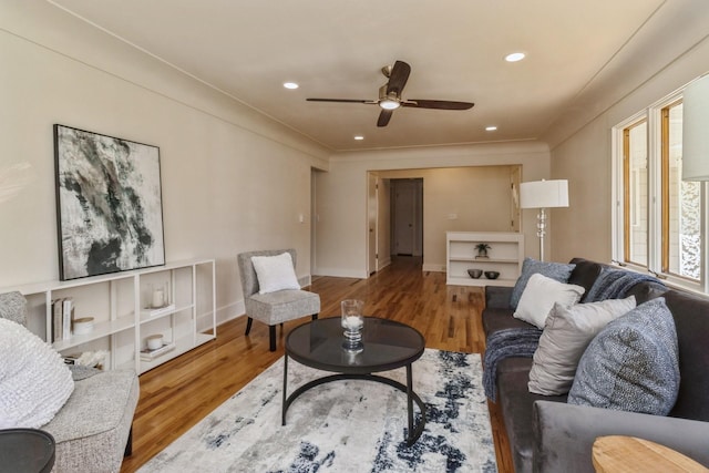 living room featuring ceiling fan, baseboards, wood finished floors, and recessed lighting