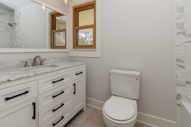 bathroom with a tile shower, tile patterned flooring, vanity, and toilet